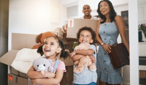 What to do While Movers are Working. Moving, happy and real estate with family in new house for investment, property and future. Smile, boxes and purchase with children and parents for mortgage, excited and homeowner relocation