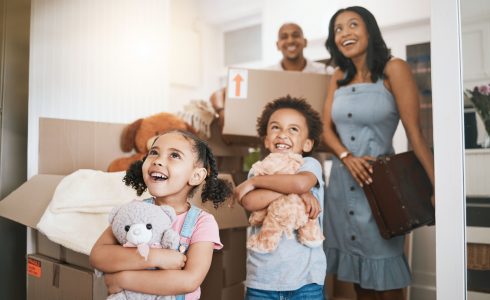 What to do While Movers are Working. Moving, happy and real estate with family in new house for investment, property and future. Smile, boxes and purchase with children and parents for mortgage, excited and homeowner relocation