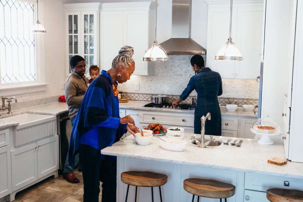 Multigenerational family cooking in new kitchen