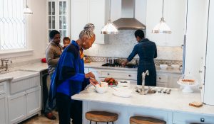 Multigenerational family cooking in new kitchen