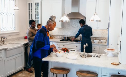 Multigenerational family cooking in new kitchen